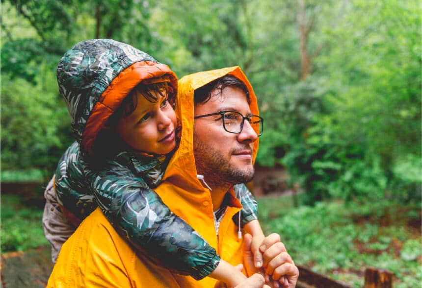 A man and his son wearing raincoats in the woods near Graham, Washington.